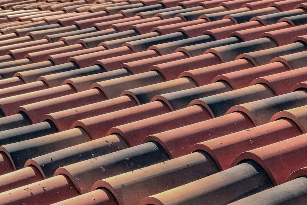 large rooftop with multiple red and gray tiles, representing a roofing website design for Fort Worth