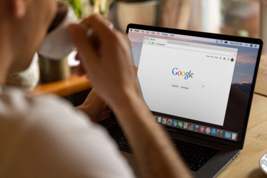 person working on a computer, representing the first design for Irving roofing website
